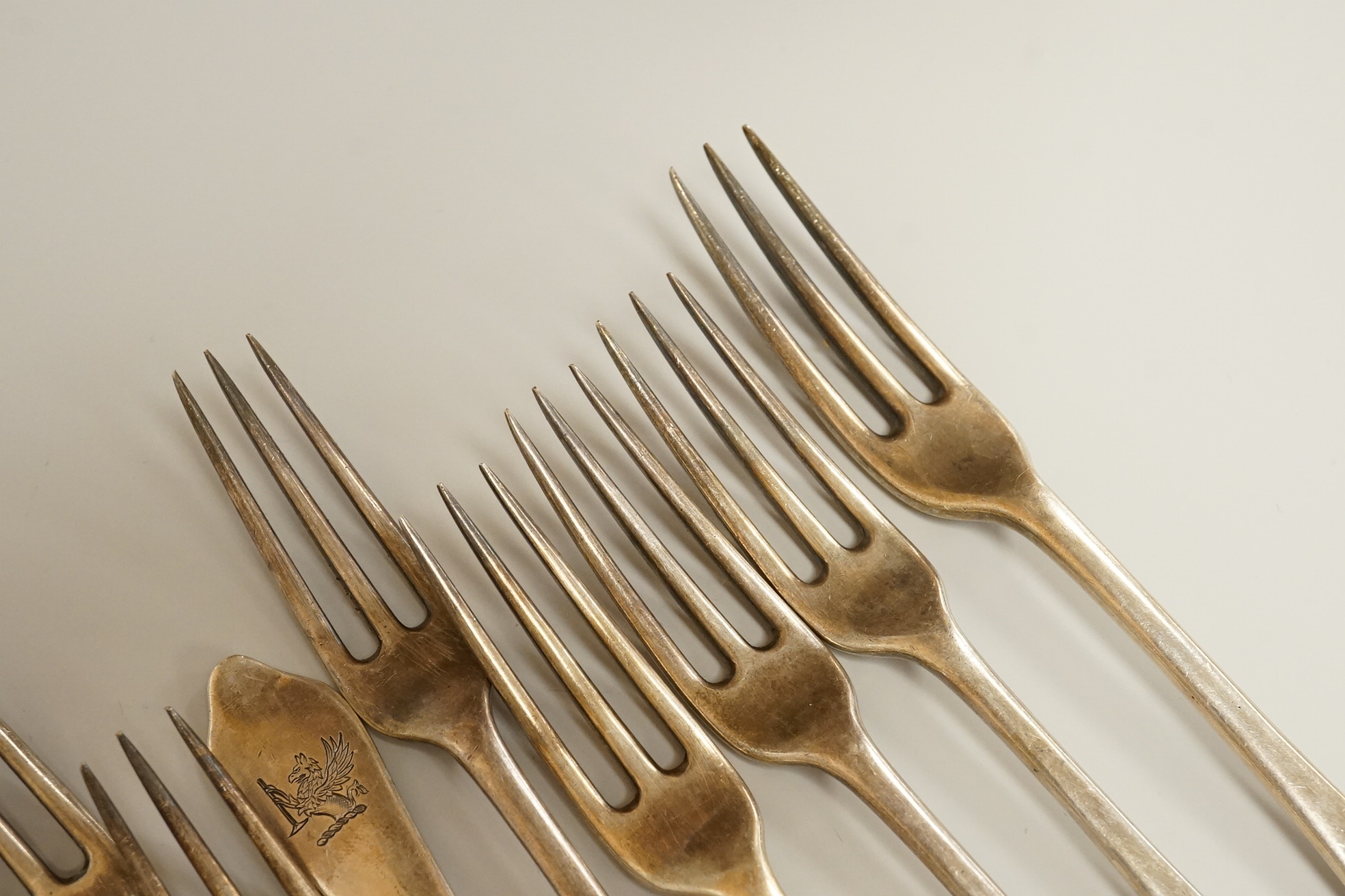 A set of seven late Victorian silver dog-nose three pronged table forks and ten matching dessert forks, all with engraved crest, Francis Higgins’s III, London, 1889, table fork length 19.5 cm, 34.5 oz.